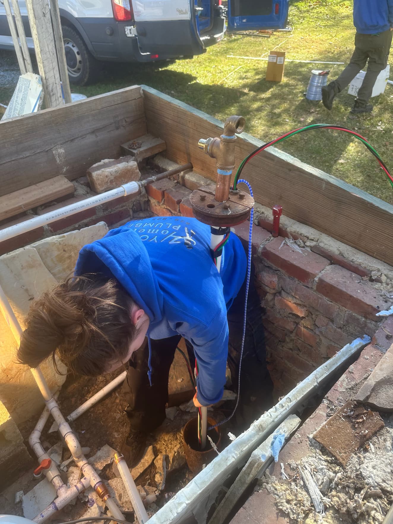 Two Your Hometown Plumber technicians repairing underground sewer line in Western NC